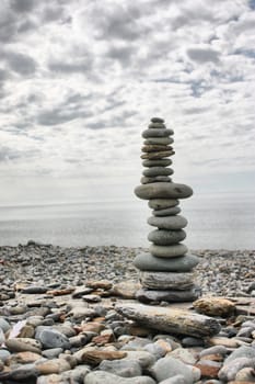 stones balancing on top of each to make a tower on a beach