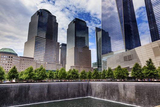 911 Memorial Pool Fountain Waterfall Skyscrapers Buildings New York NY.  Pool is in the foundation of one of the Two World Trade Center Buildings.  Water falls into hole of the foundation.  