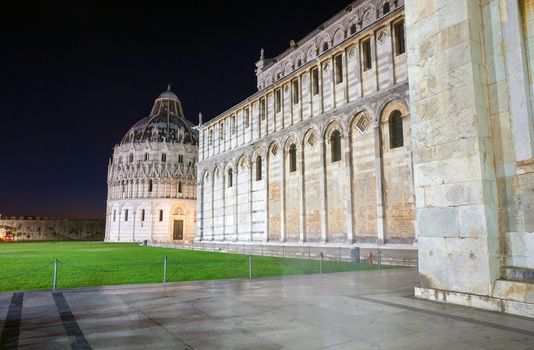 Pisa, Italy - August 11, 2013: Pisa, Piazza del Duomo with Battistero, Basilica and the leaning tower, Italy
