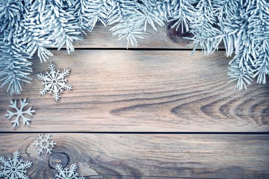 Winter background with spruce tree covered with snow and white snowflakes. Copy space. Top view