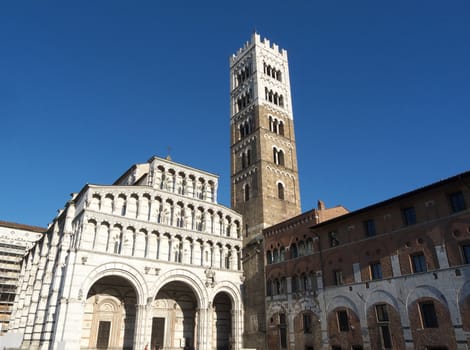 Facade and bell tower of the Lucca cathedral church of St Martin in a beautiful summer day with blue sky, Tuscany, Italy, Europe.