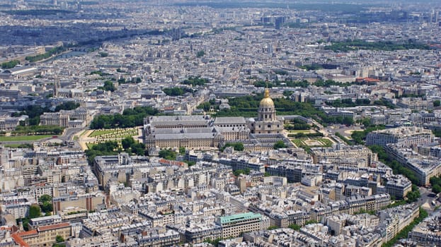 Photo is showing various views onto Paris, France with its many houses and roofs.