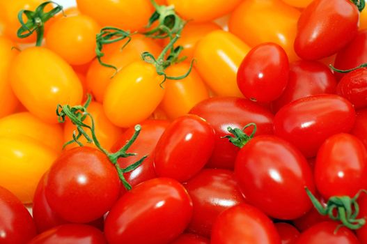 Red and yellow tomatoes cherry as background