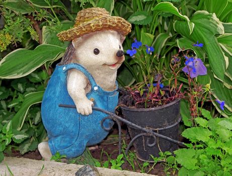 Figure of a hedgehog-gardener with hat and with trolley