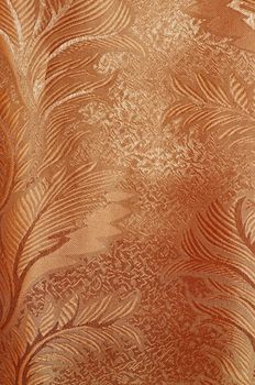 Texture of red and beige satin patterned curtains with folds