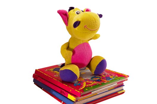 soft toy dragon on a pile of children's books