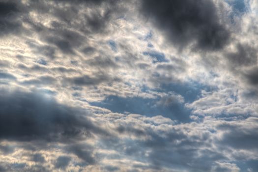 Photo shows general view of clouds with blue sky.