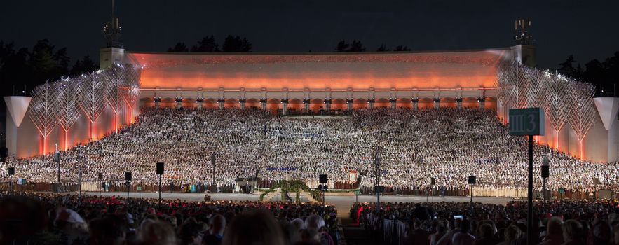 RIGA, LATVIA - July 7, 2013: The Latvian National Song and Dance Festival Grand Finale concert "Ligo!". Digitaly photomerged panorama view of grand stage