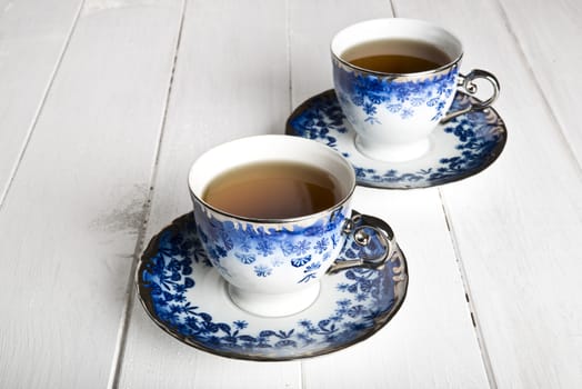 Blue tea cups in white wooden table