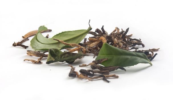 Brown dry and fresh green leaves of tea on the white background