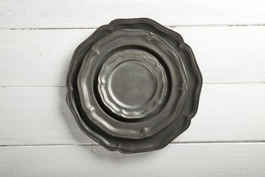 Tin texture plates on white wood table