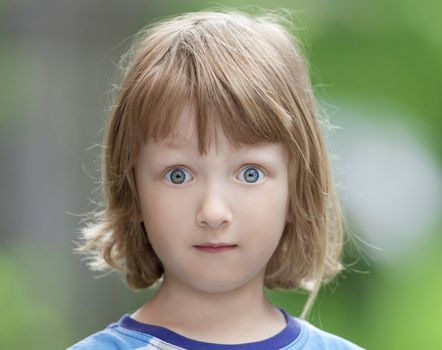 Portrait of a Boy with Long Blond Hair Looking