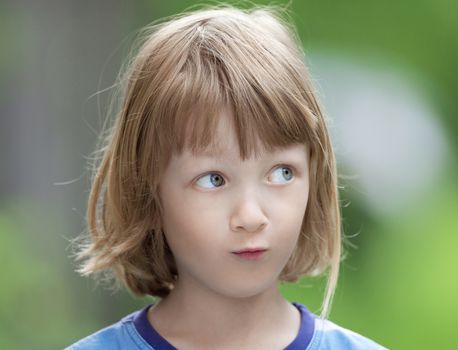 Portrait of a Boy with Long Blond Hair Looking