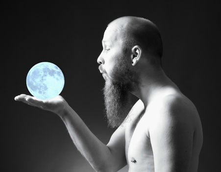 Man with Goatee Beard Holding a Blue Moon in his Hand