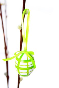 Easter egg individually hanging on a branch with white background