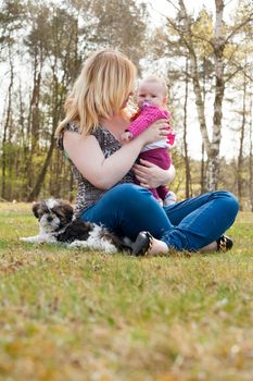 Mother is having a trip with the baby and dog outside