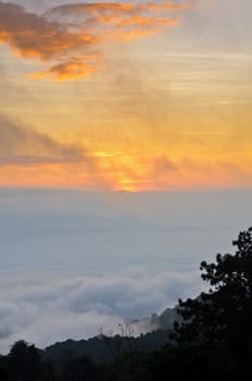 Colorful sunrise above the clouds from high mountain at viewpoint Huai Nam Dang national park in Chiang Mai and Mae Hong Son province of Thailand