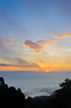 Colorful sunrise above the clouds from high mountain at viewpoint Huai Nam Dang national park in Chiang Mai and Mae Hong Son province of Thailand