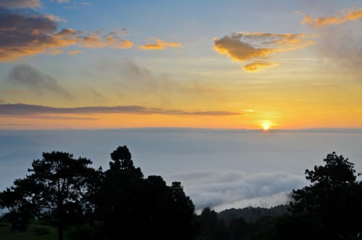 Colorful sunrise above the clouds from high mountain at viewpoint Huai Nam Dang national park in Chiang Mai and Mae Hong Son province of Thailand