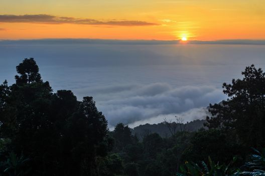 Colorful sunrise above the clouds from high mountain at viewpoint Huai Nam Dang national park in Chiang Mai and Mae Hong Son province of Thailand