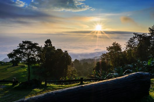 Colorful sunrise above the clouds from high mountain at viewpoint Huai Nam Dang national park in Chiang Mai and Mae Hong Son province of Thailand