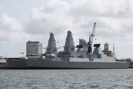 large grey warships moored in portsmouth harbour