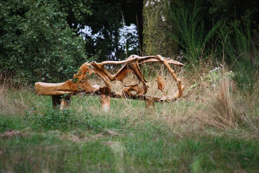 wooden sculpture art exhibit in a wooded area