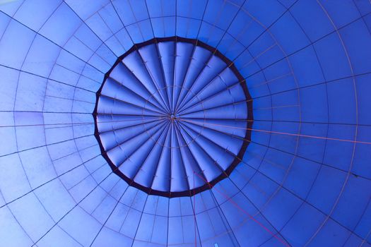 The inside of a large blue hot air balloon