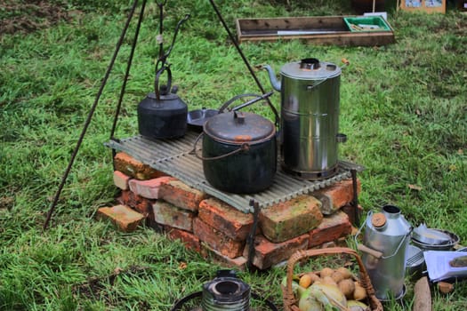 old fashioned cooking pots over an open fire