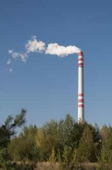 Steam rising from chimney, air pollution concept.