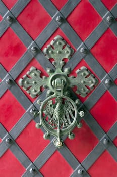 Close up view of an ornamental castle door knocker.