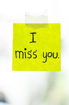 I miss you word sticky note on window mirror