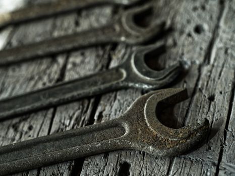 Old wrenches on a wooden background