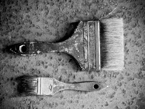Old brushes over a rusty metal background