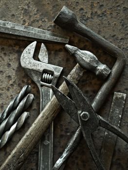 Old tools on a rusty metal background