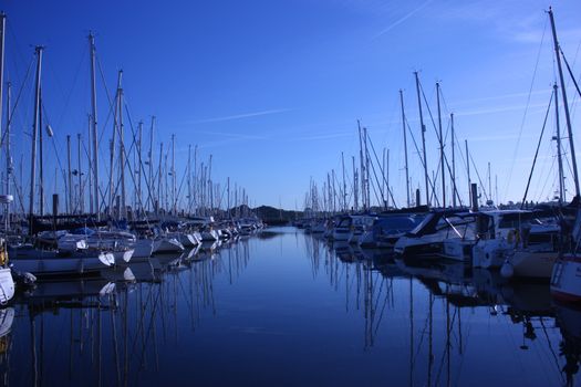 sailing and power boats moored in lymington marina