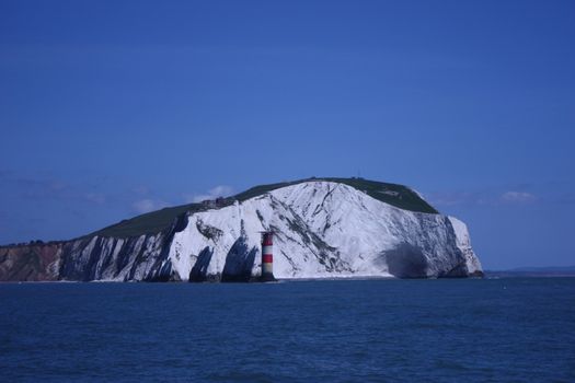 white cliffs towering above a blue sea