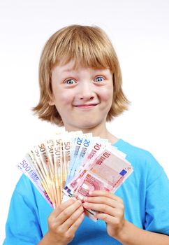 BOY WITH BLOND HAIR HOLDING UP EURO BANKNOTES.