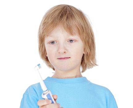 boy with blond hair in blue top brushing his teeth - isolated on white