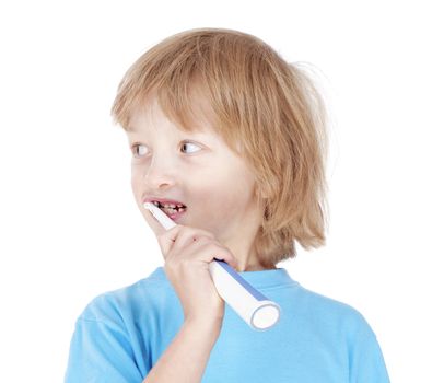 boy with blond hair in blue top brushing his teeth - isolated on white