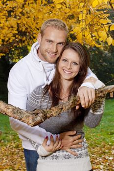 portrait of a happy young couple in the park, embracing, smiling.