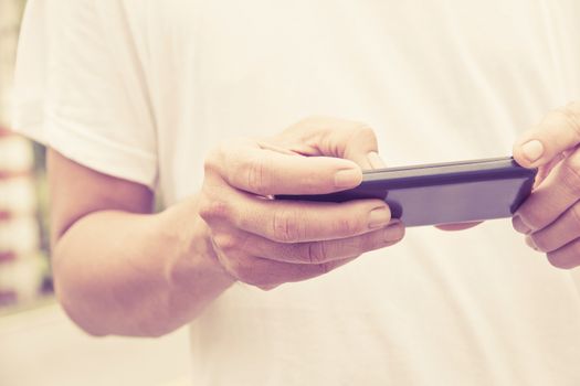 Image of man checking his phone