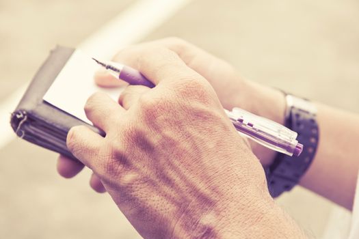 Close up image of Businessman Writing Notes