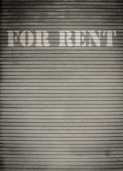 For Rent Sign On Dirty Scratched Store Roller Shutters