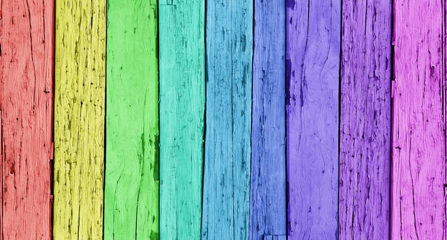 Colorful wood background with a vertical wooden row of rainbow colors.