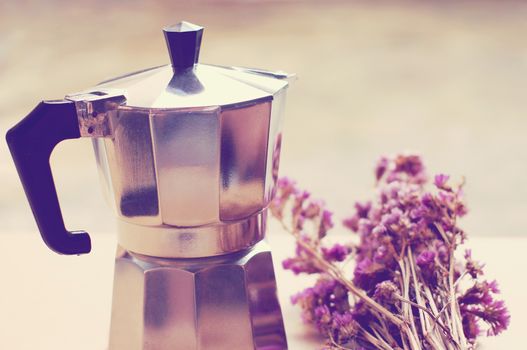 Italian coffee maker and flower with retro filter effect