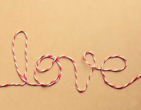 The word "love" written with rope, retro filter effect