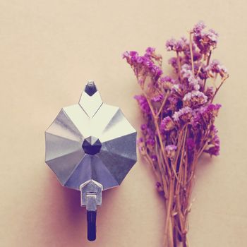 Italian coffee maker and flower with retro filter effect