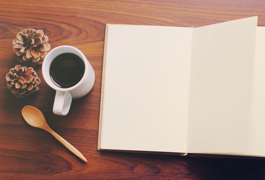 Blank notebook and coffee with retro filter effect