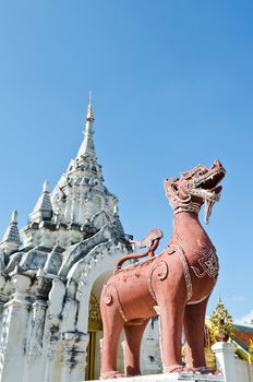 Red Lion statue at front Wat Phra That Hariphunchai temple in Lamphun Province of Thailand